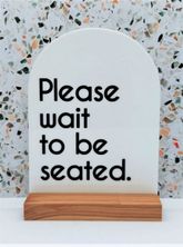 SIGN - PLEASE WAIT TO BE SEATED WHT ARCH
