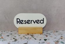 RESERVED SIGN OVAL WHITE W/BASE 100MM
