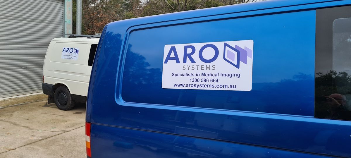 ARO Systems delivery vans in front of a shed roller door