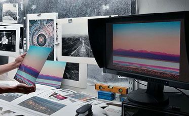 Photography office with EIZO monitor and prints