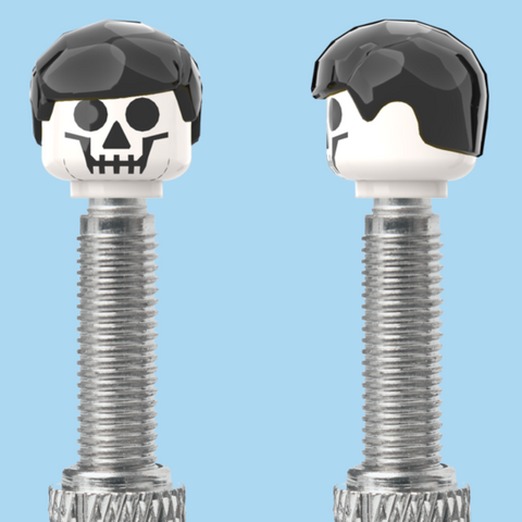 `A NEW ITEM  -  VALVE CAP, F/V, skull, short black hair, sold in pairs