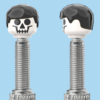 `A NEW ITEM  -  VALVE CAP, F/V, skull, short black hair, sold in pairs