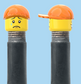 `A NEW ITEM  -  VALVE CAP, A/V, open mouth smile & sad tear face, orange hat, sold in pairs