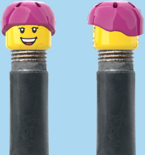 `A NEW ITEM  -  Brick Caps - Schrader Valve - 2 Face Head with Freckles & Lipstick (Open Mouth Smile & Closed Eye Smile) with a Pink Helmet