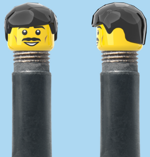 `A NEW ITEM  -  Brick Caps - Schrader Valve - 1 Face Head (Moustache Smile) with a Black Fringe Hairdo