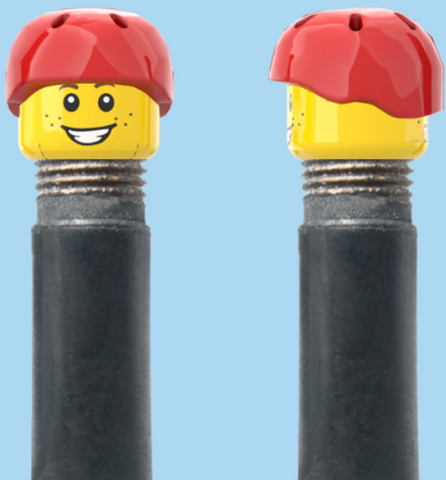 `A NEW ITEM  -  Brick Caps - Schrader Valve - 2 Face Head (Freckles Smile & Freckles Worried Look) with a Red Helmet