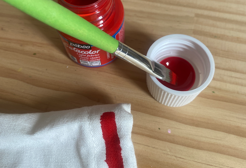 fabric paint with brush in it