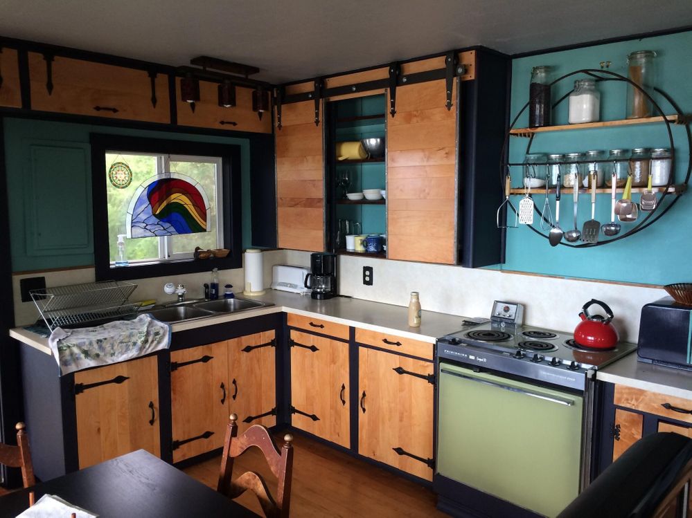 A colourful Airbnb kitchen with timber cupboards