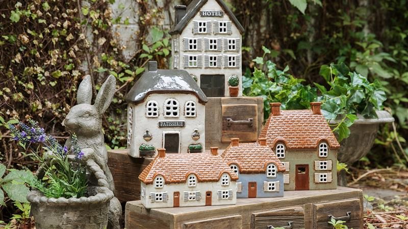 <h2>The Village Awaits</h2><button>Explore Tea Light Houses</button>