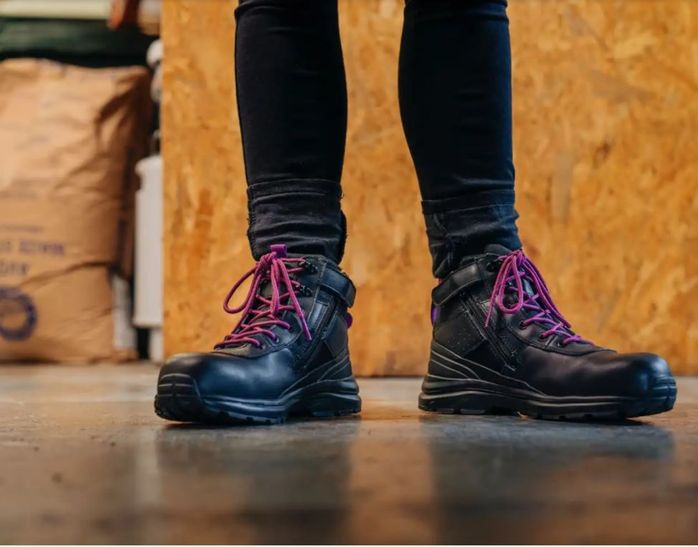 Woman wearing black safety boots for work