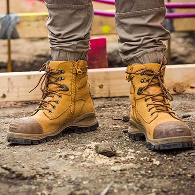 A pair of dirty work boots on a work site 