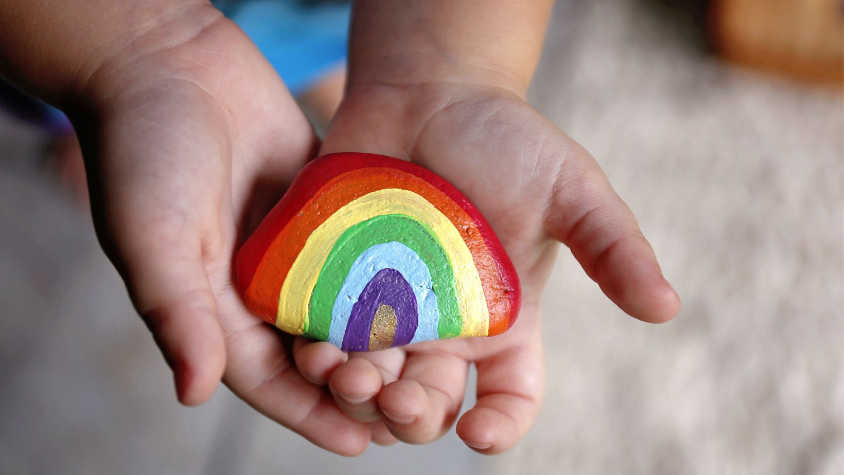 Painted pebble in hand 