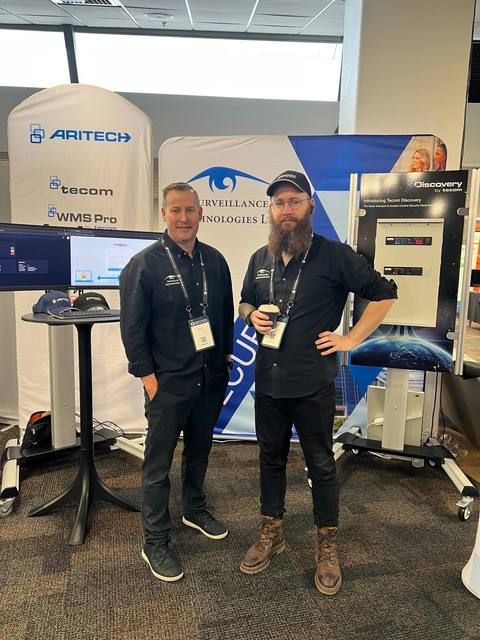 Robert McDowell and Patrick on the Surveillance Technologies stand