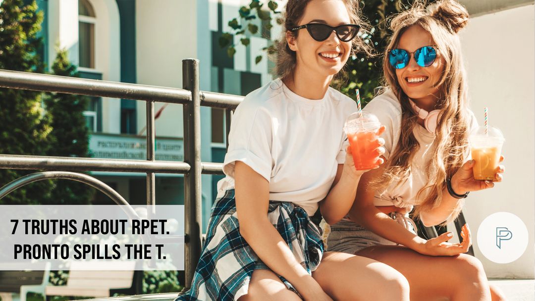 Two girls drinking smoothies outside title banner