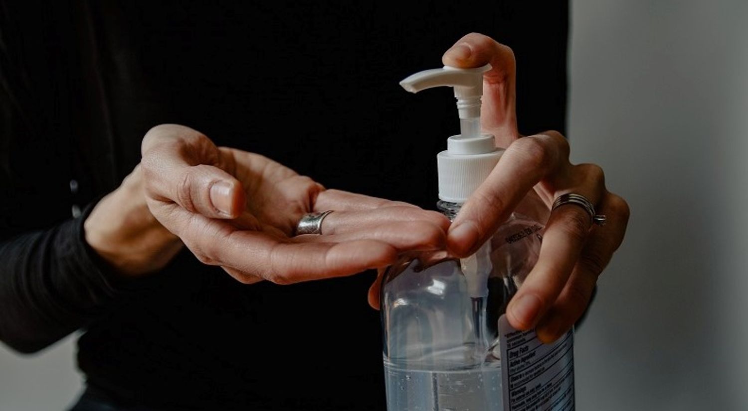 woman using hand sanitiser