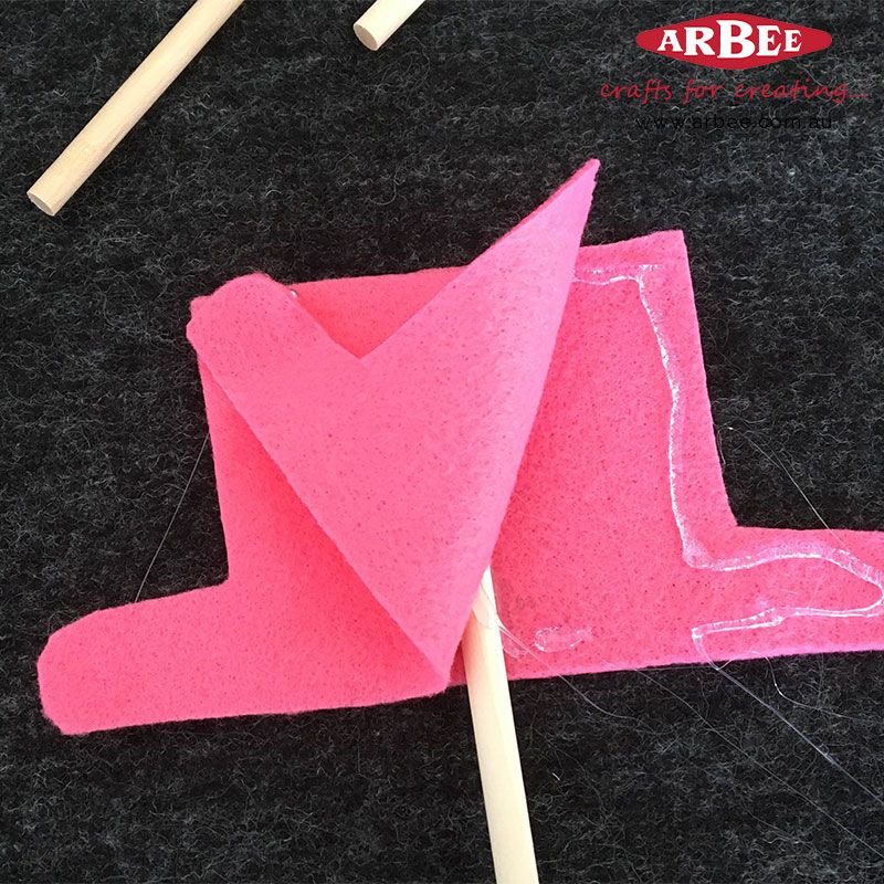 Placing the dowel rod into the felt pieces