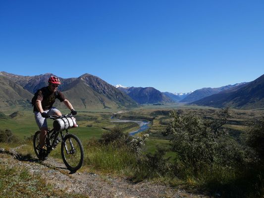 Simon, bike packing St James Cycle trail, upper Waiau in background.